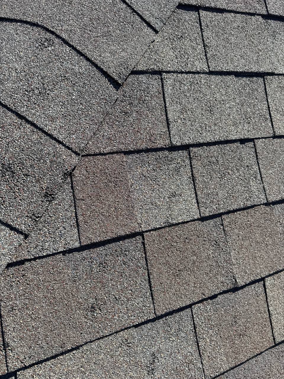 Hail-damaged shingles on a Fort Worth home