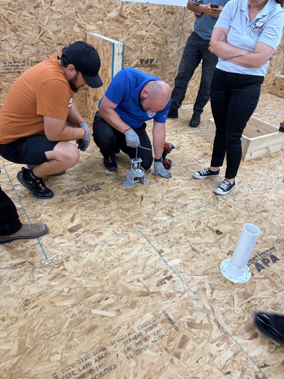 Roofer comparing metal and shingle roofing materials