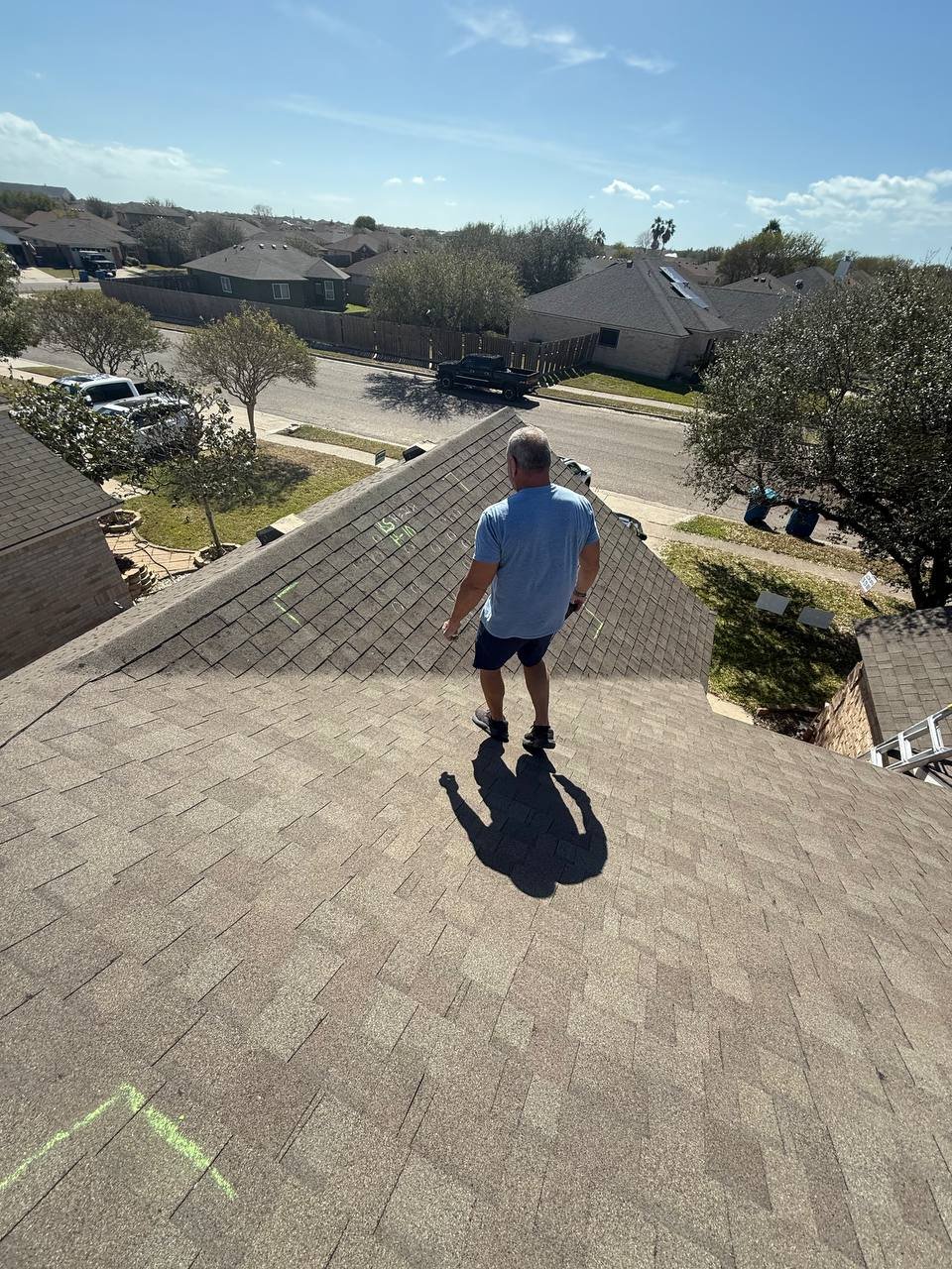 Roofer measuring a Texas roof for a replacement quote
