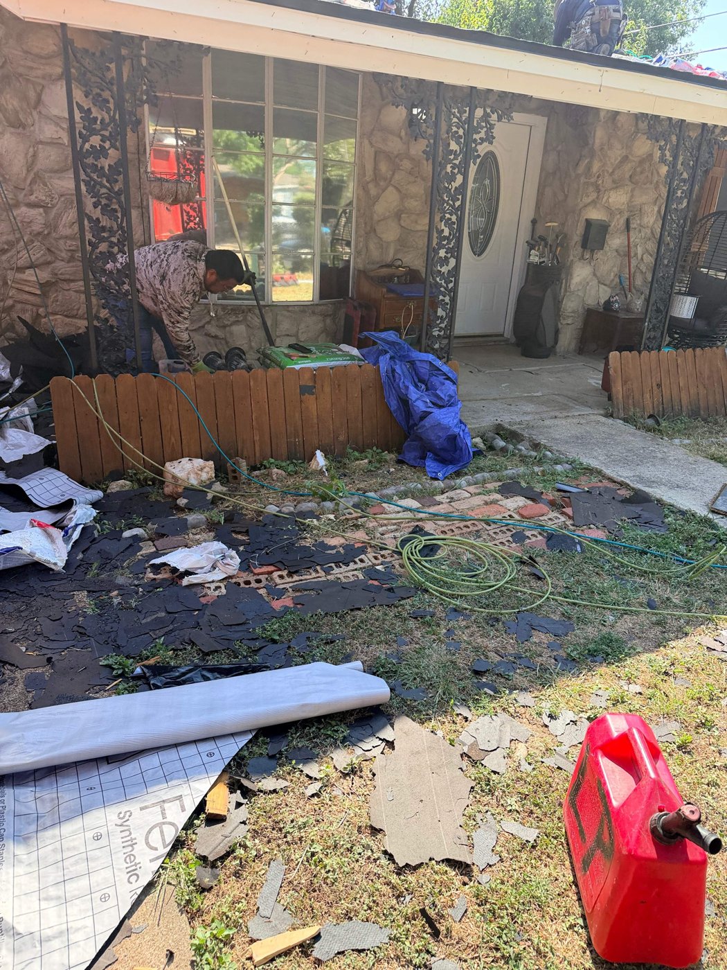 Homeowner discussing roof replacement costs with a contractor