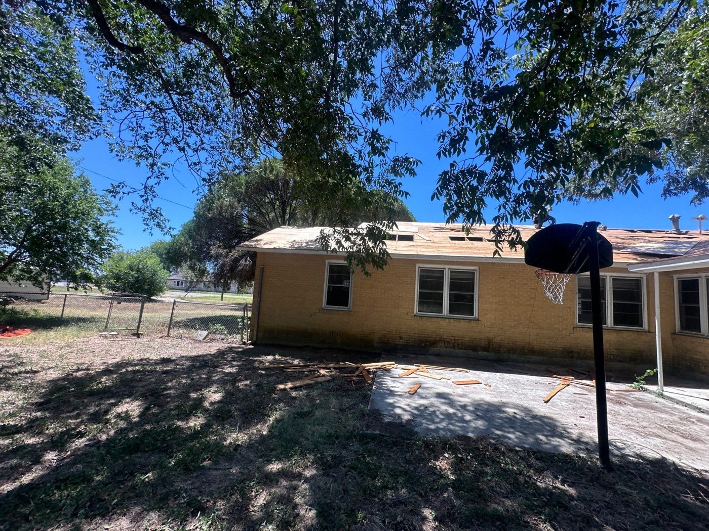 Homeowner assessing roof shingles