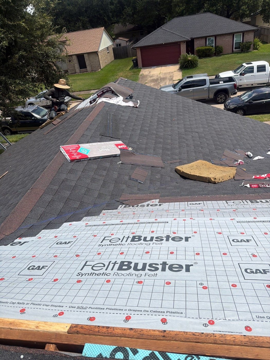 Roofer inspecting an aging Texas roof for replacement