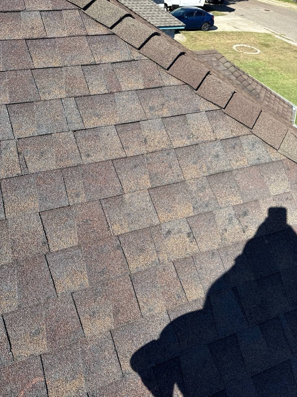Roofer inspecting the source of a roof leak