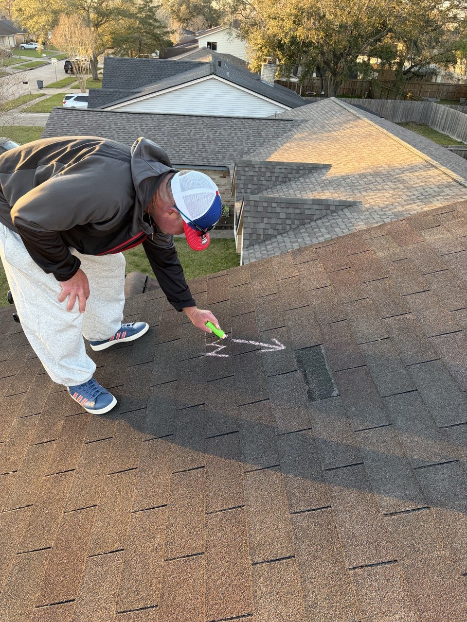Flagstone Roofing team member reviewing a roof inspection report with a homeowner