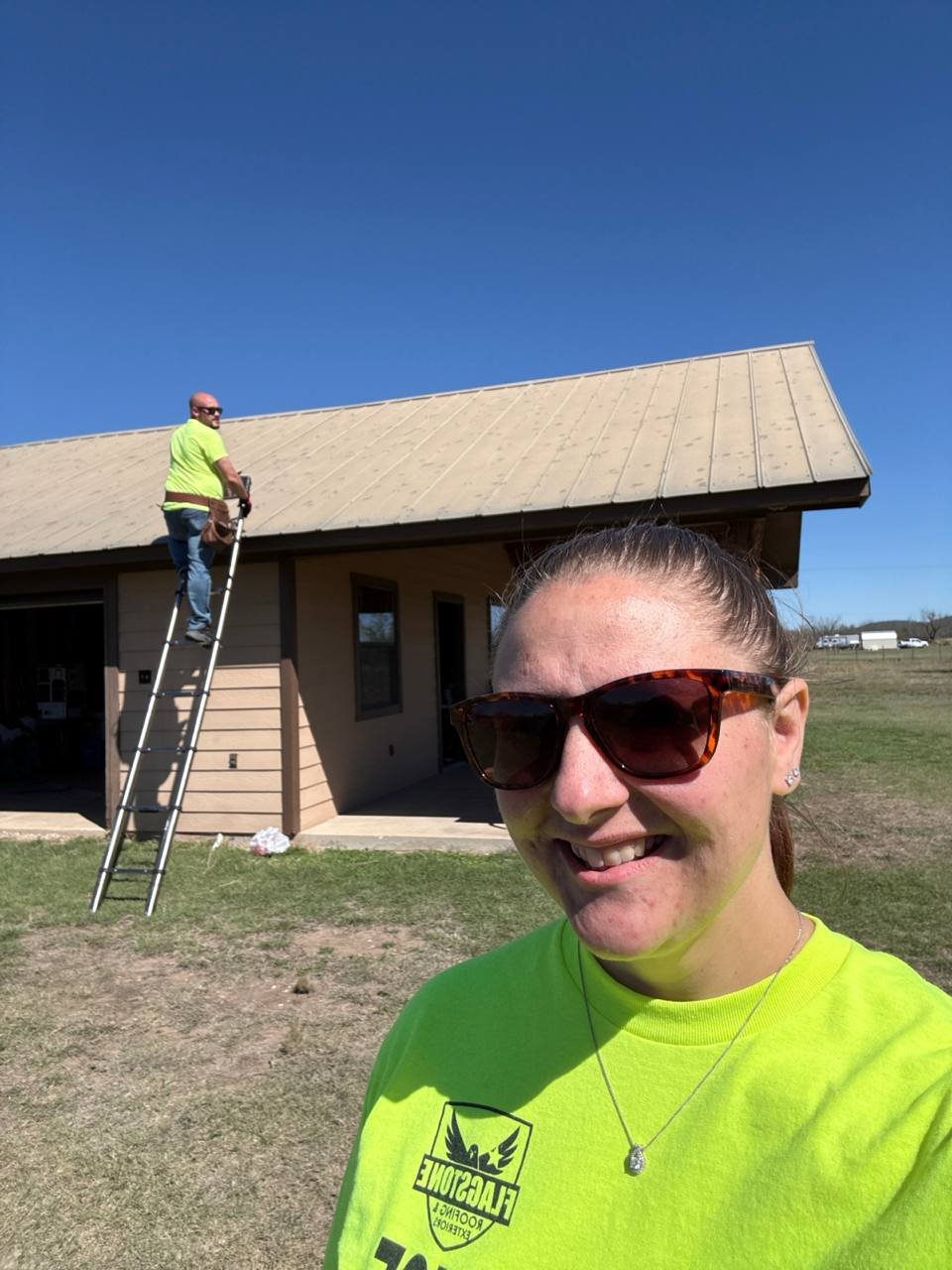 Roofer comparing a new shingle against weathered shingles