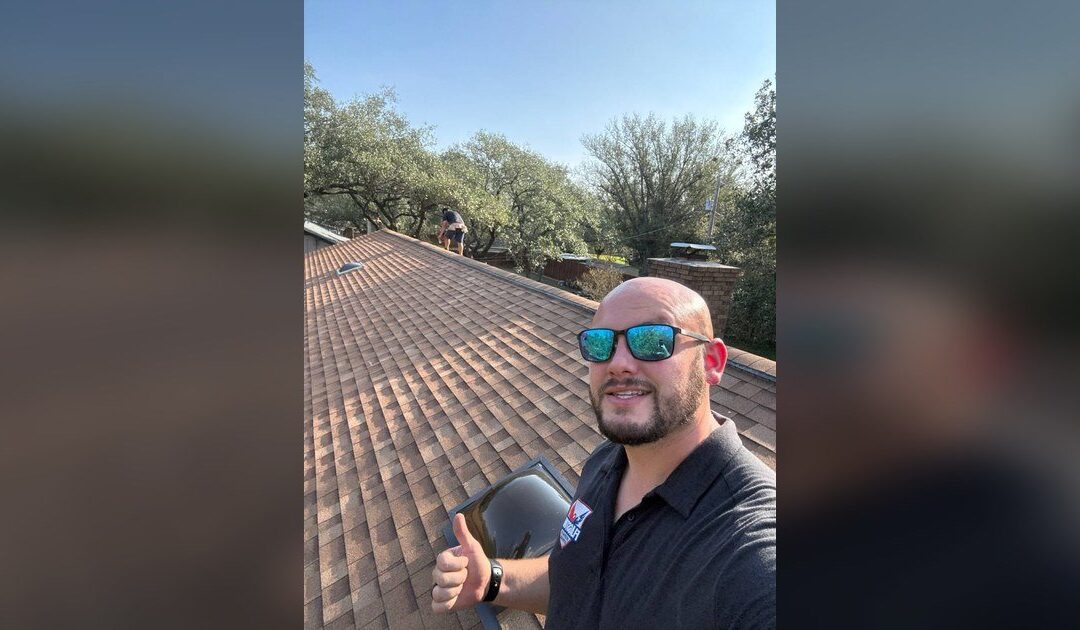 Flagstone Roofing sales rep inspecting a Texas roof during a customer appointment