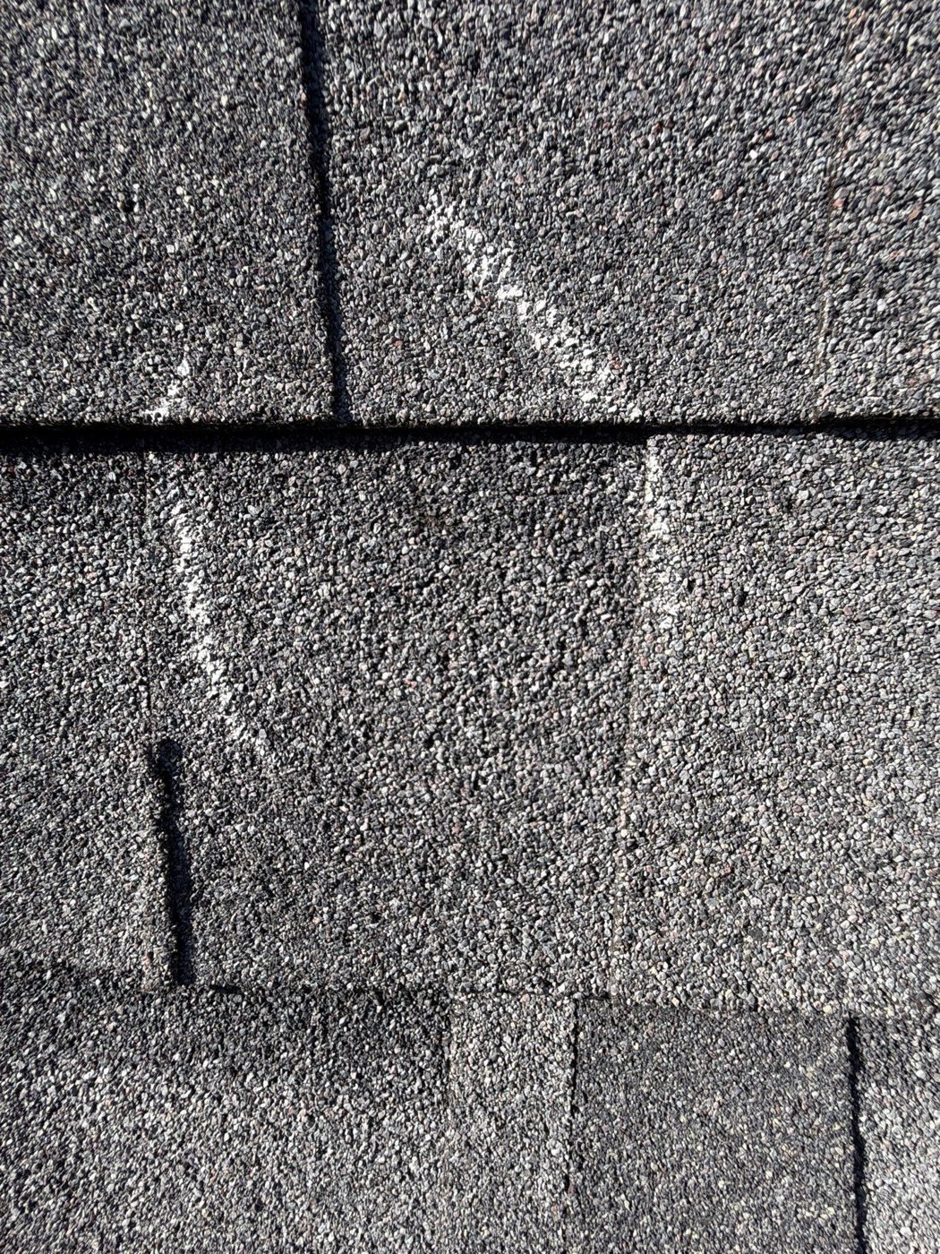 Roof damage with insurance claim paperwork